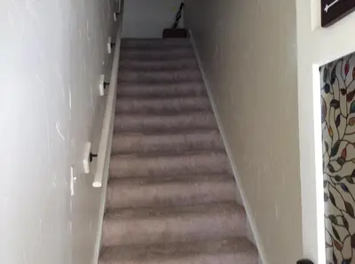 a staircase in a room with a stair case at Charming Studio Apartment in the Heart of Golden in Golden