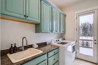a kitchen with a sink and a washing machine at Mountain Majesty home in Black Hawk