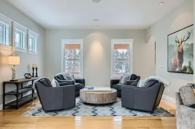 a living room with two chairs and a table at Mountain Majesty home in Black Hawk