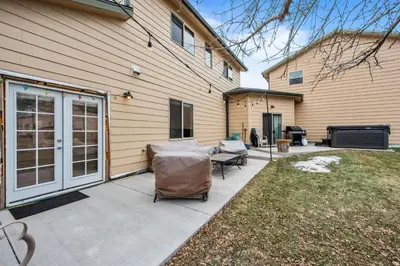 a patio with a couch and chairs next to a house at 180 S Hoyt in Lakewood