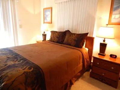 a bedroom with a large bed and two lamps at Timber Run in Winter Park