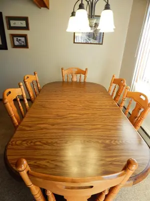 a dining room table with chairs and a large wooden table at Timber Run in Winter Park