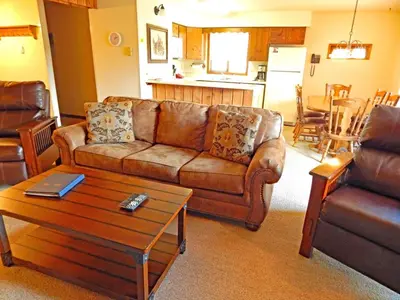 a living room with a couch and a coffee table at Timber Run in Winter Park
