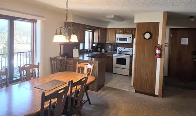 a kitchen and dining room with a wooden table and chairs at Timber Run in Winter Park