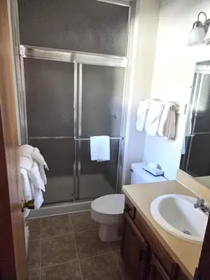 a bathroom with a shower and a toilet and a sink at Timber Run in Winter Park