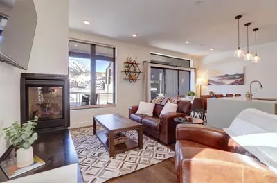 a living room with a couch and a fireplace at River West 515 condo in Silverthorne