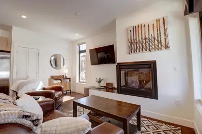 a living room with a couch and a fireplace at River West 515 condo in Silverthorne