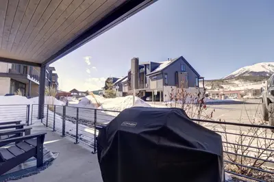 a black tent sitting on a balcony with a house at River West 515 condo in Silverthorne