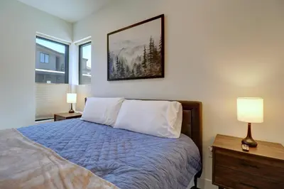 a bedroom with a bed with two lamps and a picture on the wall at River West 515 condo in Silverthorne