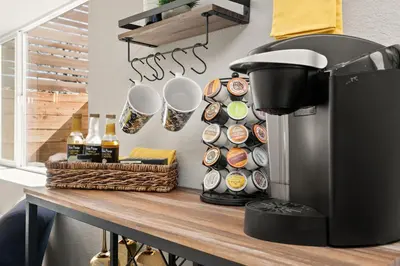 a counter with a coffee maker on a table at CSU Hideaway with King Bed, Backyard Oasis in Fort Collins