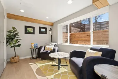 a living room with two couches and a window at CSU Hideaway with King Bed, Backyard Oasis in Fort Collins
