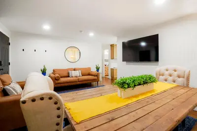 a living room with a couch and a table at BRAND NEW Classic Fire Pit 2 Kings Pet Friendly in Arvada