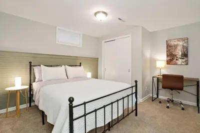 a bedroom with a bed and a desk and a chair at BRAND NEW Classic Fire Pit 2 Kings Pet Friendly in Arvada