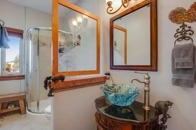 a bathroom with a bowl sink and a shower at Granby Modern Cabin - Hot Tub & Mountain Views in Granby