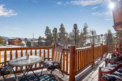 a balcony with a table and chairs on a deck at Granby Modern Cabin - Hot Tub & Mountain Views in Granby