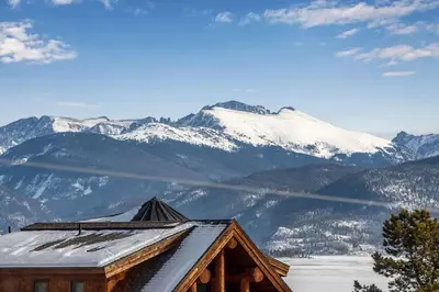 a view of a snow covered mountain from a cabin at Granby Modern Cabin - Hot Tub & Mountain Views in Granby