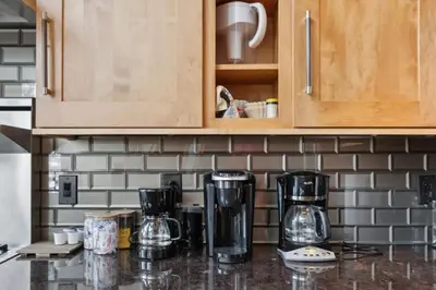 a kitchen with a counter top with two coffee makers at Luxe & Leisure in Fairways- An Oasis in the Woods in Granby