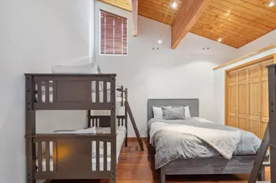 a bedroom with a bunk bed and a bunk ladder at Luxe & Leisure in Fairways- An Oasis in the Woods in Granby