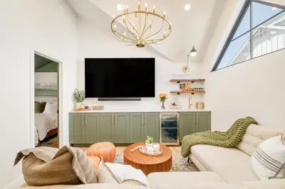 a living room with a tv and a couch at Luxe Designer Flat on Sloans Lake with Rooftop Deck in Denver