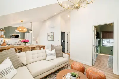 a living room with a couch and a table at Luxe Designer Flat on Sloans Lake with Rooftop Deck in Denver