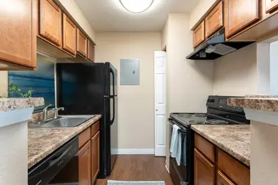a kitchen with a black refrigerator and a sink at Johnny André Velásquez gutierrez in Aurora