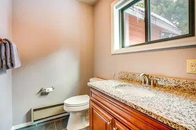 a bathroom with a toilet and a sink and a window at Home with Mtn Views in Frisco Near 3 Ski Resorts! in Frisco