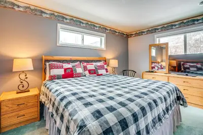 a bedroom with a bed and a mirror at Home with Mtn Views in Frisco Near 3 Ski Resorts! in Frisco