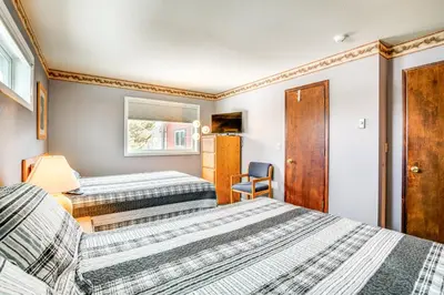 a bedroom with two beds and a chair at Home with Mtn Views in Frisco Near 3 Ski Resorts! in Frisco