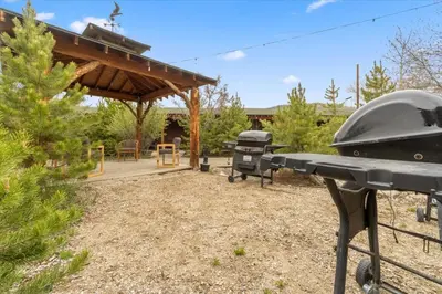 a backyard with a grill and a picnic table at Black Bear Studio in Tranquil Courtyard by Grand Luxe in Grand Lake