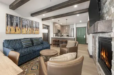 a living room with a couch and a fireplace at Select Unit 2509 - Zephyr Mountain Lodge condo in Winter Park