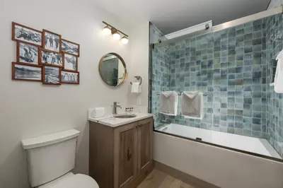 a bathroom with a toilet and a tub and a sink at Select Unit 2509 - Zephyr Mountain Lodge condo in Winter Park