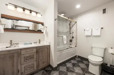 a bathroom with a toilet and a sink and a shower at Select Unit 2509 - Zephyr Mountain Lodge condo in Winter Park