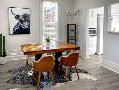 a dining room with a wooden table and two chairs at Downtown Boulder Luxury in Boulder