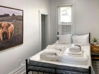 a bed in a bedroom with a picture of a cow at Downtown Boulder Luxury in Boulder