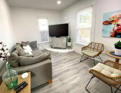 a living room with a couch and a flat screen tv at Downtown Boulder Luxury in Boulder