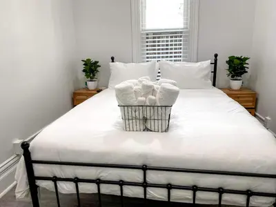 a bed with two baskets of towels on it at Downtown Boulder Luxury in Boulder