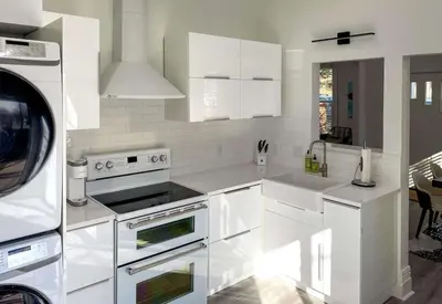 a white kitchen with white appliances and a microwave at Downtown Boulder Luxury in Boulder