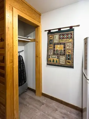 a rug hanging on a wall next to a closet at Grand Lake Haven in town, Osprey Studio Cabin in Grand Lake