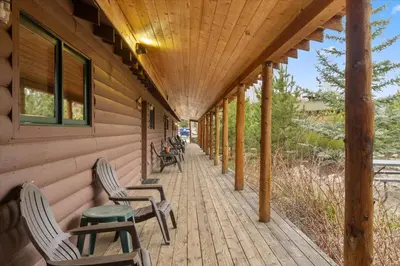 a porch of a house with chairs and a table at Grand Lake Haven in town, Osprey Studio Cabin in Grand Lake