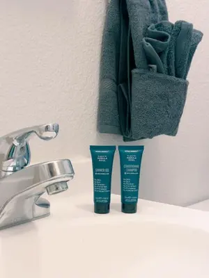 a bathroom counter with two bottles of toothpaste and a sink at Cozy cabin Steps from Lake and Board walk, 5 min RMNP, Moose Lodge Studio in Grand Lake