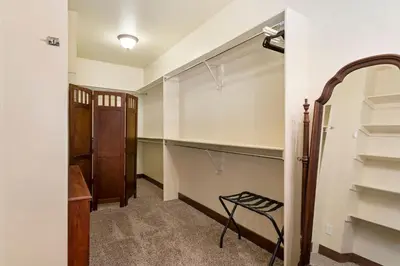 a walk in closet with a chair in a room at The Fireside Retreat - 6 BD, Sauna, Home Theater in Greeley