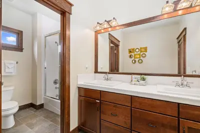 a bathroom with two sinks and a toilet at The Fireside Retreat - 6 BD, Sauna, Home Theater in Greeley