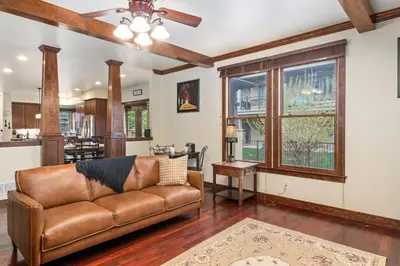 a living room with a brown leather couch at The Fireside Retreat - 6 BD, Sauna, Home Theater in Greeley
