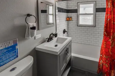 a bathroom with a sink and a toilet and a tub at groovy apartment in the heart of the city in Denver