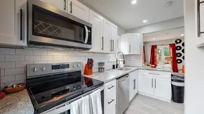 a kitchen with a stove and a microwave at groovy apartment in the heart of the city in Denver