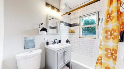 a white bathroom with a sink and a toilet at groovy apartment in the heart of the city in Denver