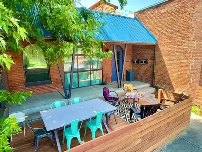 a patio with a blue table and chairs at Unique denver loft in rino art district in Denver