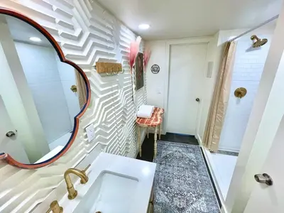 a bathroom with a sink and a mirror at Unique denver loft in rino art district in Denver