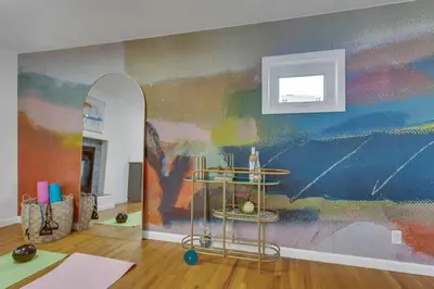 a room with a colorful wall with a mirror at 15min to Denver - AirHockey - Arcade - Minigolf - Sleeps10 in Westminster