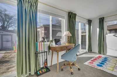 a room with a desk and a chair and a window at 15min to Denver - AirHockey - Arcade - Minigolf - Sleeps10 in Westminster